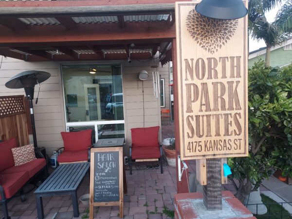 A sign for north park suites in front of the building.