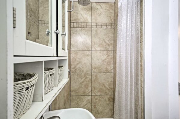 A bathroom with a shower and tiled walls.