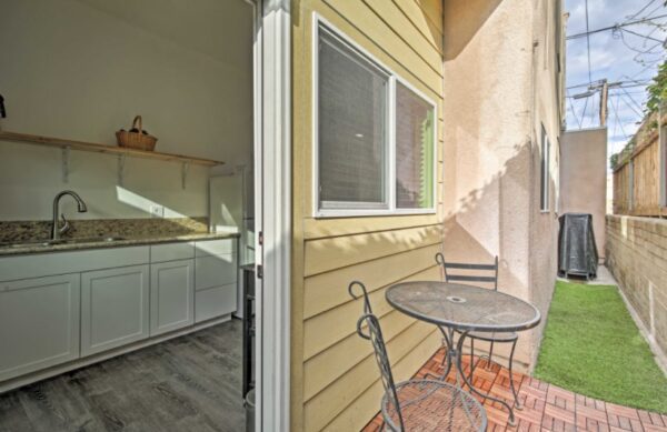 A table and chairs on the porch of a house.