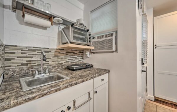 A kitchen with a microwave and sink in it