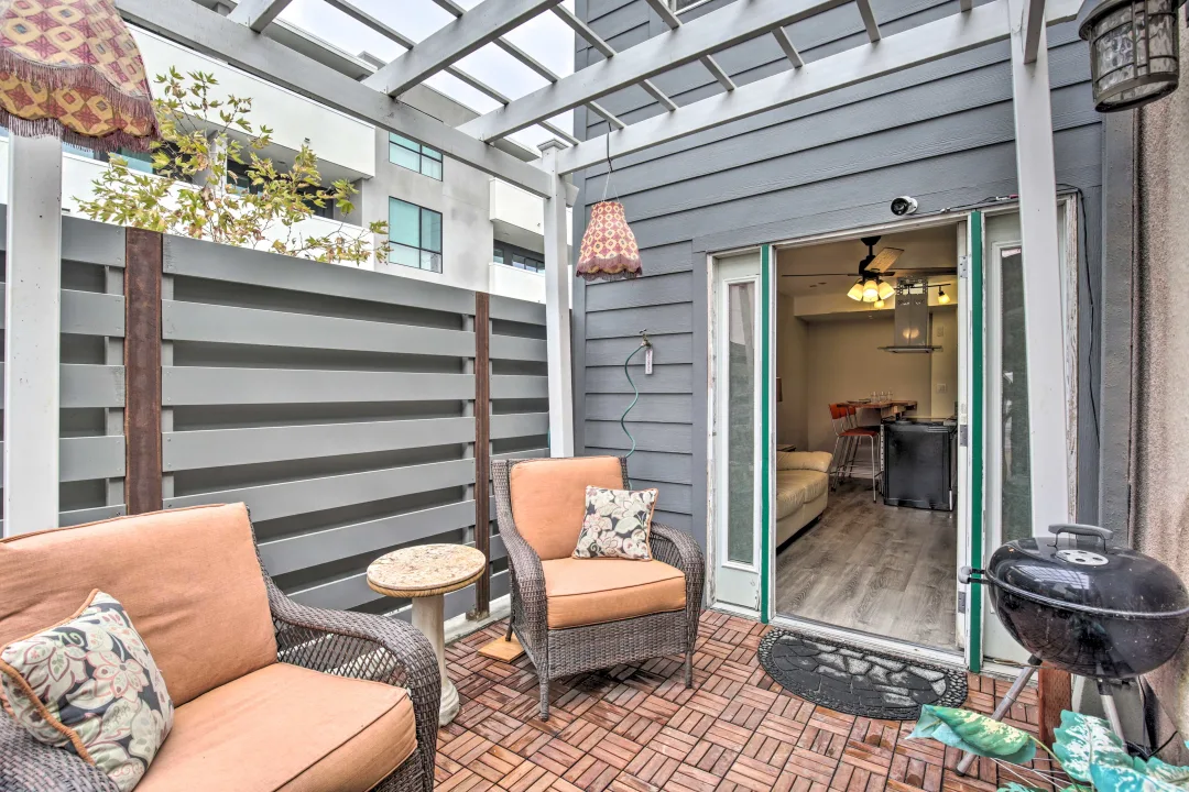 A patio with two chairs and tables outside