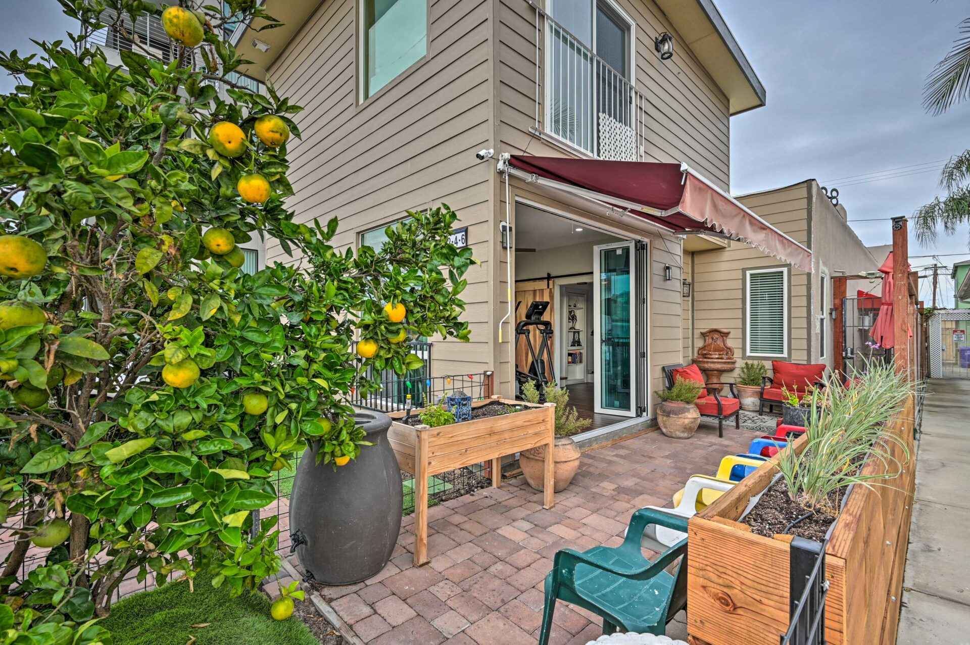 A patio with chairs and tables outside of it